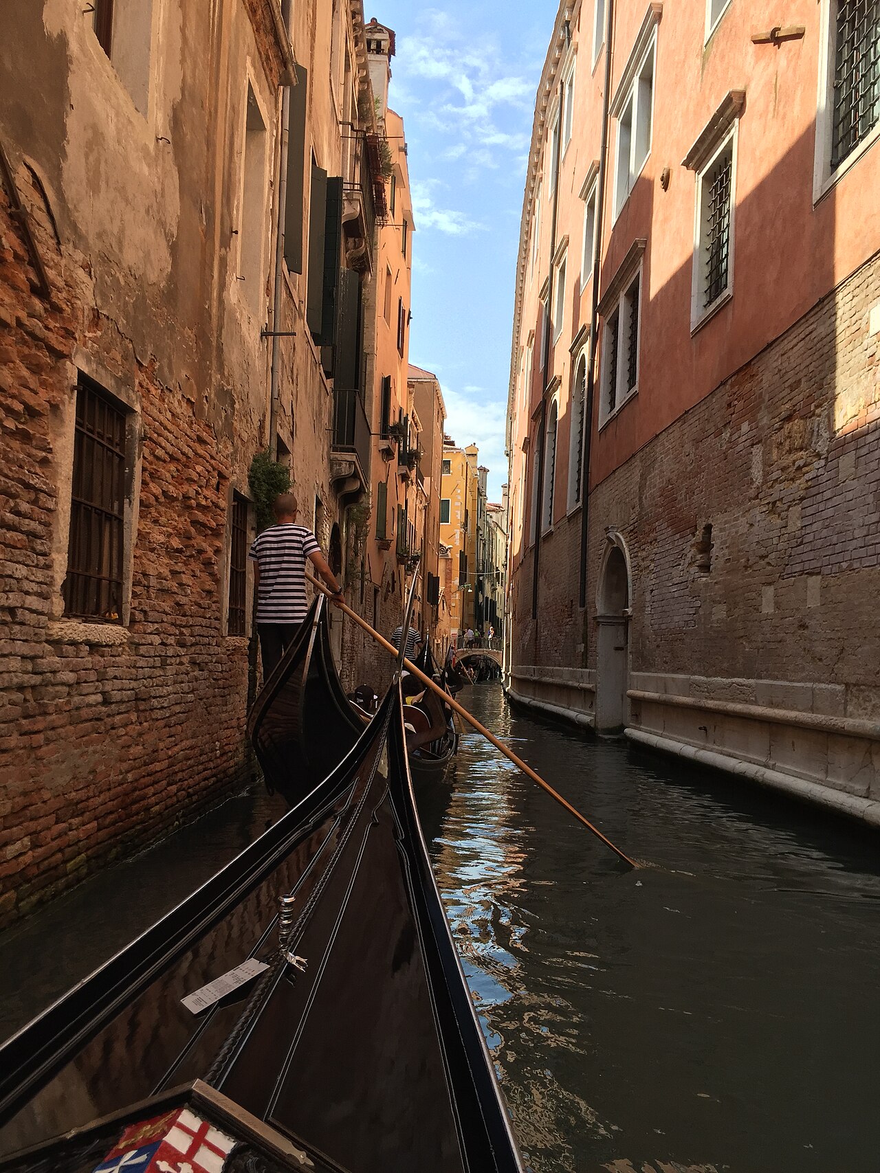 Gondola moving through a narrow canal in Venice, Italy